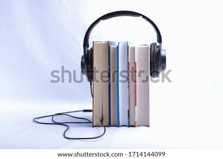 book and headphones. concept of audiobooks and education