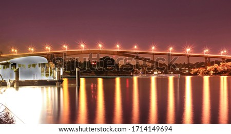 Night Long exposure of Gladesville Bridge in Sydney Australia illuminated by the bright lights and smooth harbour waters light up 