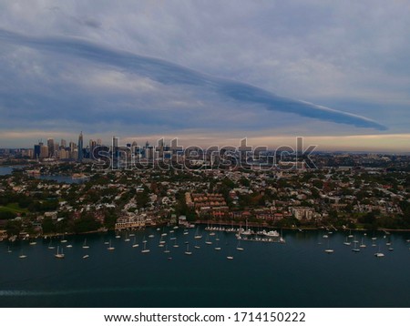 Panoramic drone aerial view over Sydney harbour at sunset showing the nice colours of the harbour foreshore