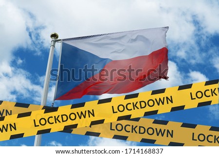 Czech Republic flag against the sky and a protective tape with the inscription lockdown. Concept - Czech Republic is quarantined due to the coronavirus epidemic.