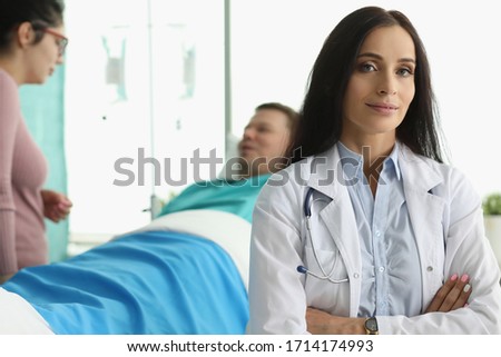 Man lies in hospital bed next to woman doctor. Range services for surgical treatment diseases varying complexity. Medicine use modern and proven practice diagnostic and treatment methods