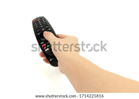 black remote control in hand isolated on white background.