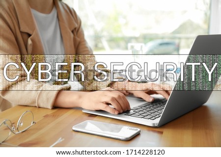 Cyber security concept. Woman working with laptop at table indoors, closeup
