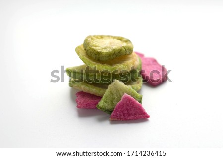 red and green vegetable chips, healthy snack on a white background
