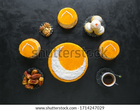 Festive food Ramadan background. Delicious homemade golden cake with a Crescent moon, served with black coffee and dates. Top view.