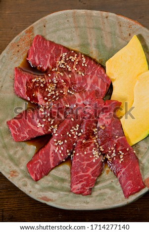 Raw meat beef with sesame seed for babecue(BBQ) and pumpkin in plate.Top view 