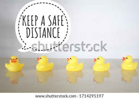 Conceptual photo using yellow duck toys to show the importance of social distancing to prevent covid-19 