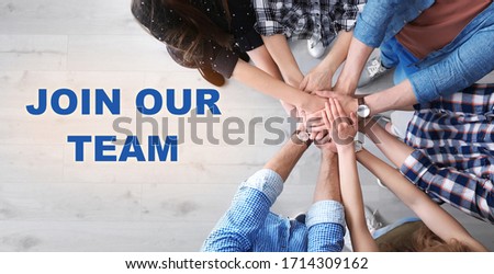 People putting hands together, top view. Join our team Royalty-Free Stock Photo #1714309162