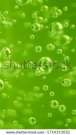 Close-up of green transparent gel with Bubbles. Background from texture liquid gel cream. Drops of  oxygen serum  in the bottle