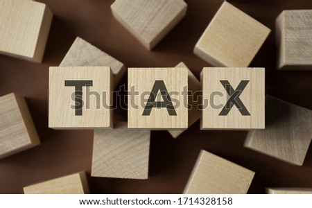 word with dice on white background - tax