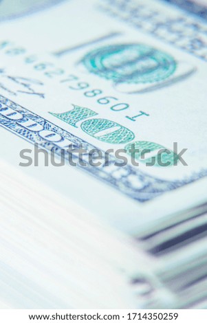 Stack of hundred US Dollar bills. Shot with shallow depth of field. Selective focus.