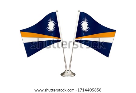 Marshall İslands table flag isolated on white ground. Two flag poles with flags and Marshall İslands flag on the table.