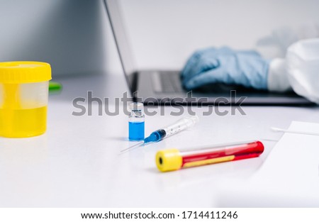 Stock photography of scientist working with laptop with special equipment in laboratory