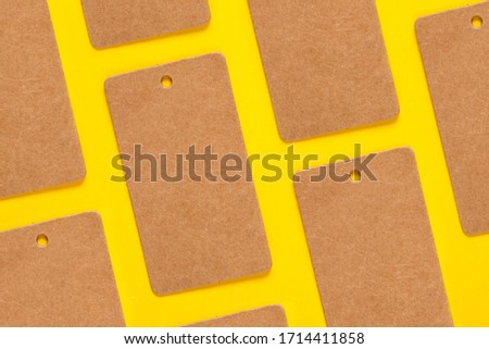 Blank clothing labels pattern on yellow background, craft paper tags pattern