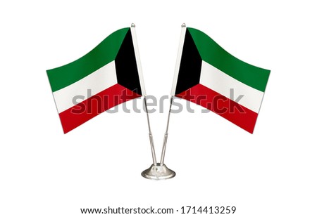Kuwait table flag isolated on white ground. Two flag poles with flags and Kuwait flag on the table.