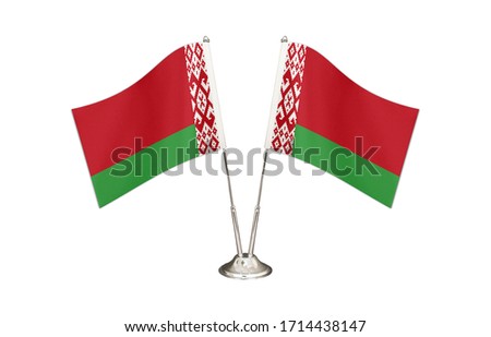 Belarus table flag isolated on white ground. Two flag poles with flags and Belarus flag on the table.