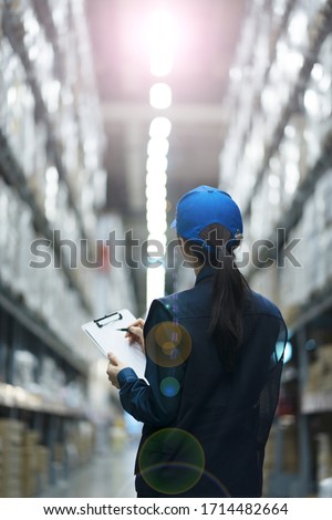 Warehouse worker taking inventory in logistics warehouse Royalty-Free Stock Photo #1714482664