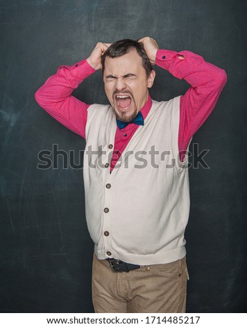 Funny thick screaming teacher or business man on blackboard background