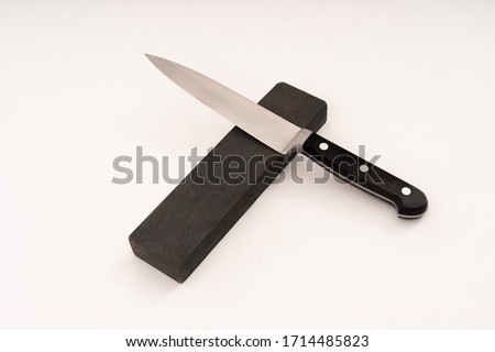Knife sharpening with whetstone sharpener. isolate on white background. selective focus.