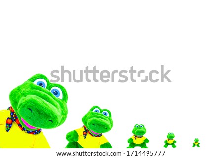 Plush stuffed crocodile toy isolated on a white background descending with space for text. It can be used for greeting cards and children's greetings.