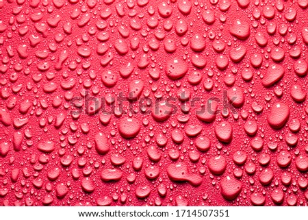 Macro water drops texture on a red backdrop. Abstract pattern or blank for design.