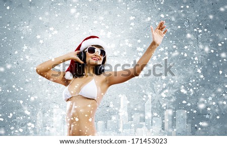 Young woman in swimming suit and santa hat