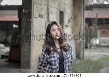 
Portrait of sweet girl wearing a plaid shirt and pants