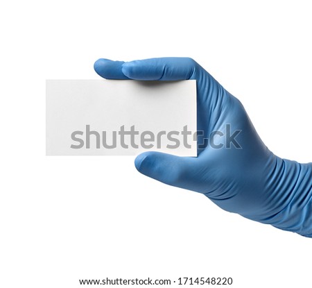close up of a hand with blue latex protective gloves holding a paper note on white background