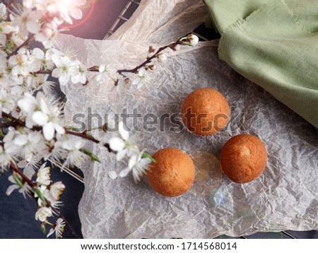 Top view of a beautiful breakfast with flowers and fresh pastries, muffins. Selective focus.