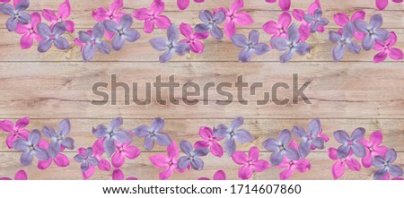 Flowers on wooden background. Lilac. Free space for text.