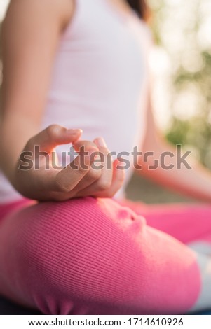 calmness and relax, female happiness. Horizontal, blurred background. little asian girl meditates while practicing yoga. freedom concept. calmness and relax, child happiness. toned picture healthy life