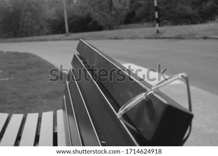 Left behind glasses on a park bench.