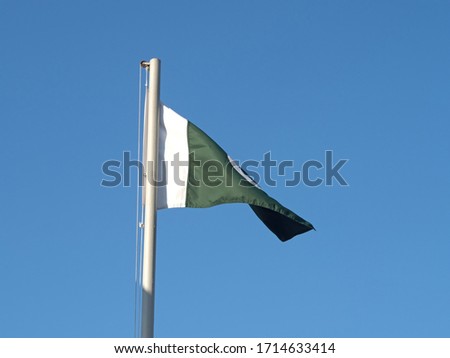 Pakistan flag in front of a clear blue sky
