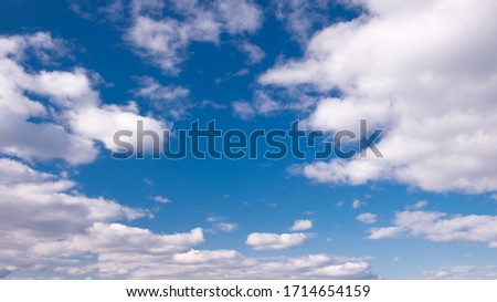Blue sky panorama with white clouds and sun  rays. Summer spring heaven concept. Background for textures backgrounds and web banners design