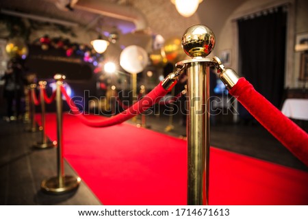 Red carpet between rope barriers in the success party Royalty-Free Stock Photo #1714671613