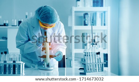 Asian scientist or doctors use microscopes to test for the coronavirus (COVID 19). Or a new flu virus to save human life In the lab Or hospital. Successful in researching the treatment of patients