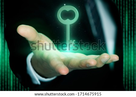 key success digital concept, a businessman showing digital glowing key on right hand