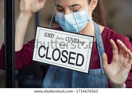 Stressed owner forced to close the restaurant permanently due to restrictions on the coronavirus. Depressed businesswoman closing her business activity due to covid-19. Small business bankrupt. Royalty-Free Stock Photo #1714676563
