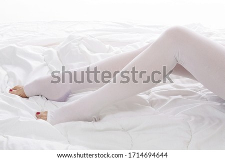 
close up bedridden senior woman wearing medical compression stockings