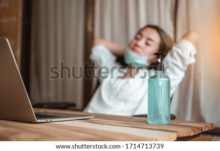 Woman work from home wearing mask protection wait for epidemic situation to improve soon at home. Coronavirus, covid-19, Work from home (WFH), Social distancing, Quarantine, Prevent infection concept. Royalty-Free Stock Photo #1714713739