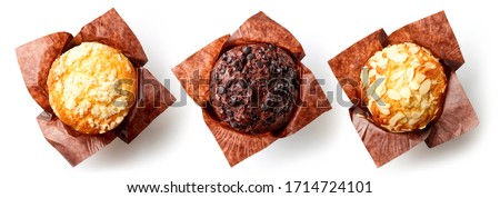 Set of assorted muffins in brown paper isolated on white background, top view Royalty-Free Stock Photo #1714724101