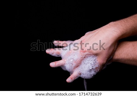 man is washing hands thoroughly with soap to protect against viruses. Cleaning and body care concept.
