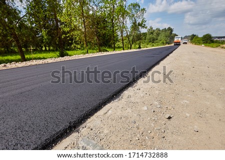 Construction of a road with rubble and sand on a sunny day