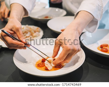 Chef cooking dinner with few dishes Royalty-Free Stock Photo #1714743469