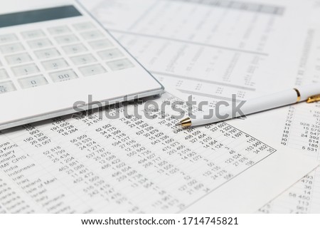 Financial accounting Pen and calculator on balance sheets Royalty-Free Stock Photo #1714745821