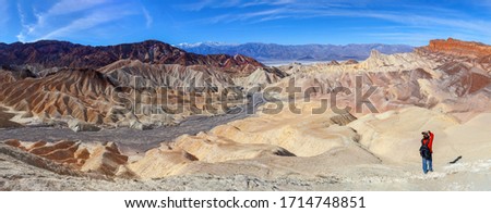 Photographer takes picture of the  Zabriskie point panorama   in Death Valley, California, USA