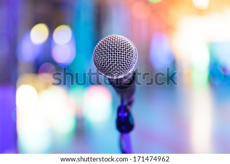 Detail of microphone with bright blurred party lights around