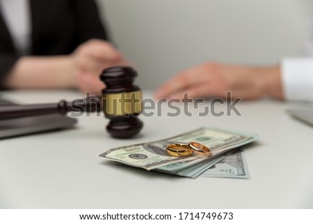 Legal alimony concept. Closeup view of wooden gavel and money. Royalty-Free Stock Photo #1714749673