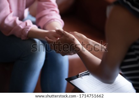 Close up of female doctor hold woman patient hands help on personal therapy session, psychologist or counselor show understanding and care, support depressed suffering client on treatment Royalty-Free Stock Photo #1714751662
