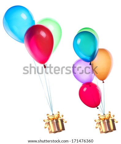 gift hanging on color balloons rising high
